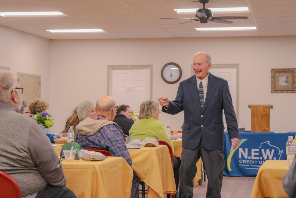 Bill board chairman greeting credit union members at annual meeting