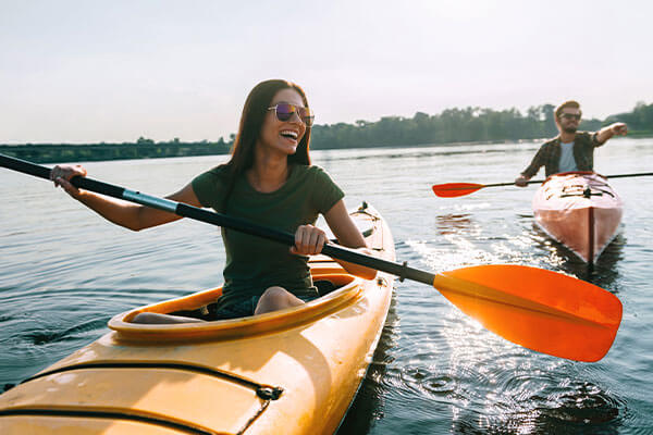Couple kayaking together on river.