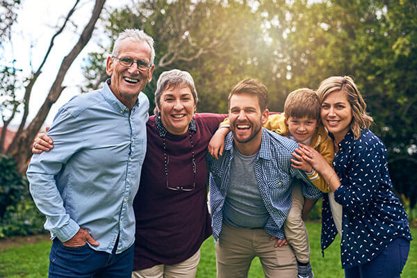 Three generations of family posing for photo.